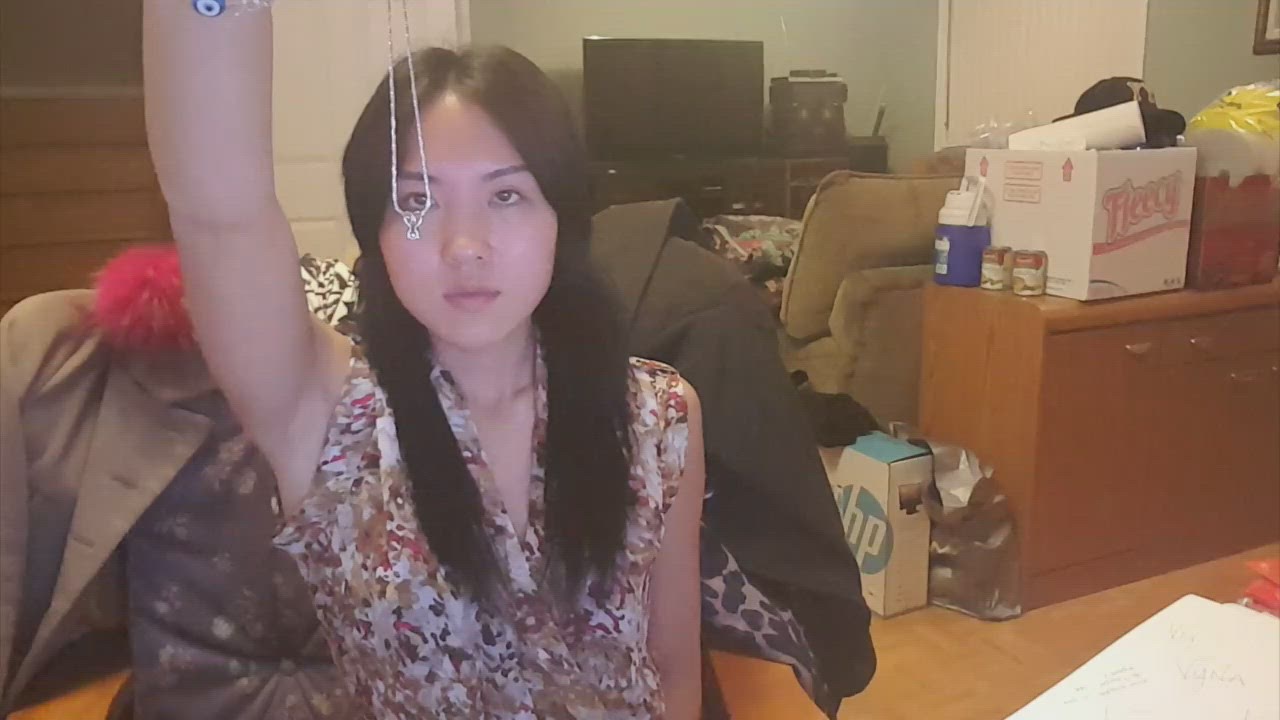 9:21 thumbnail from "suggestibiliity_tests.mp4". Bianca holds a silver pendant during a focus test, demonstrating mental command by attempting to make the pendant swing in a circular motion.